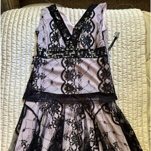 Beautiful two piece black lace over  lovely mauve lining.  Size medium.